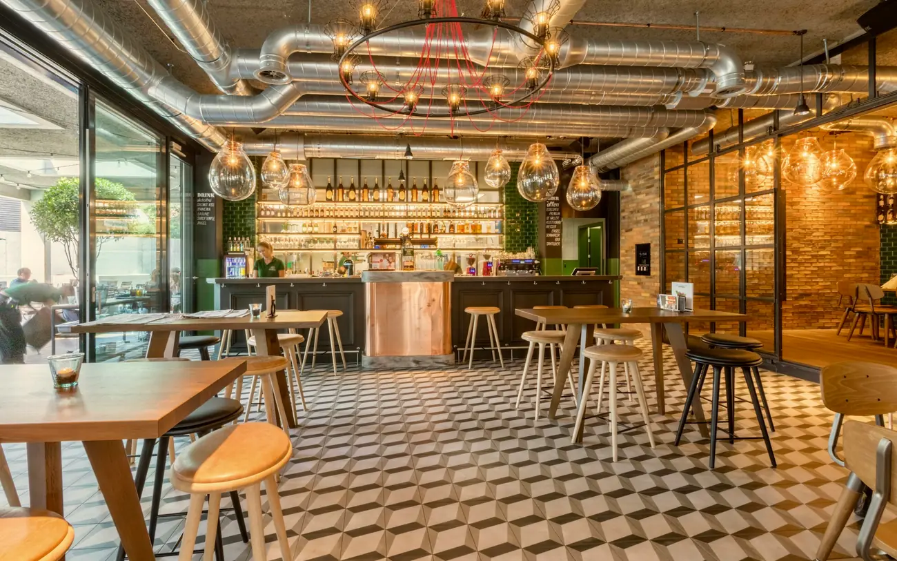 Restaurant front of house with a bar, service counter, stools and tiled floor