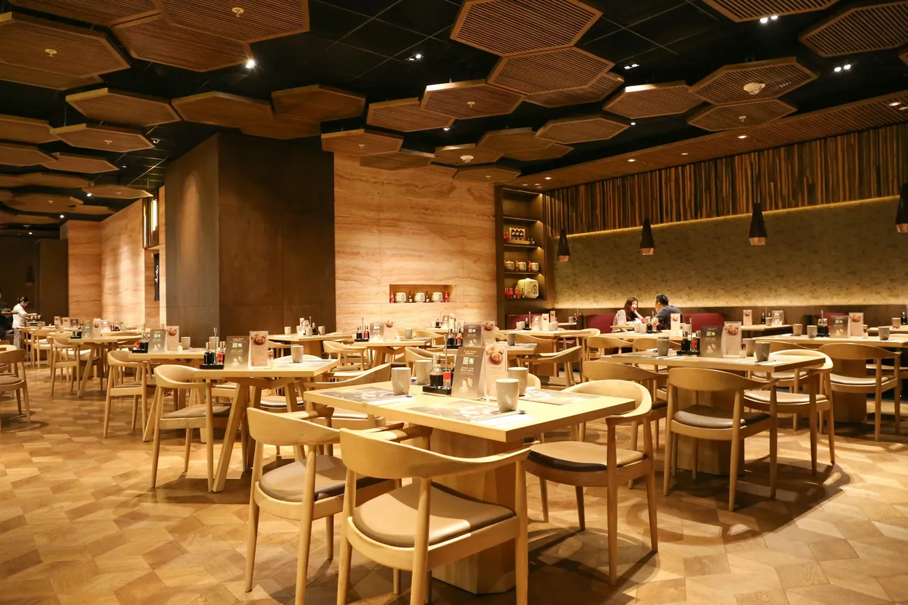 Restaurant dining room with tables and chairs on the guest-facing side of the building